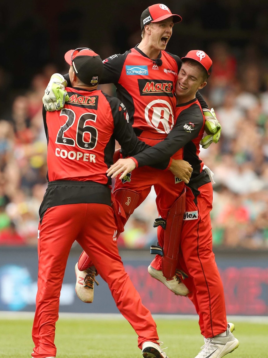 Three Renegades players hug each other during the Big Bash League final.