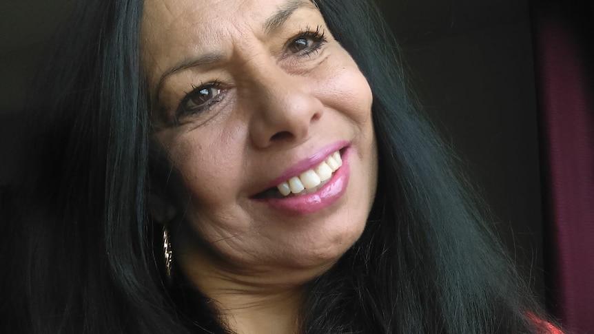 Tanya Day is smiling as she looks upwards in a close-up profile shot.