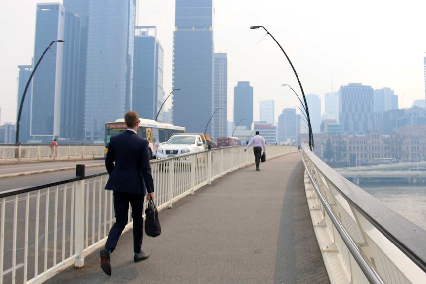 A man walks Victoria Bridge as Brisbane is blanketed with smoke from bushfires.