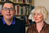 Daniel Andrews and Cath Andrews sit on a couch and talk to a camera.