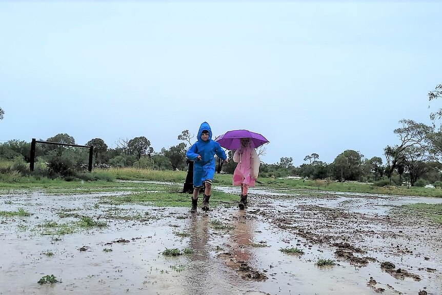 Two children play in muddy ground