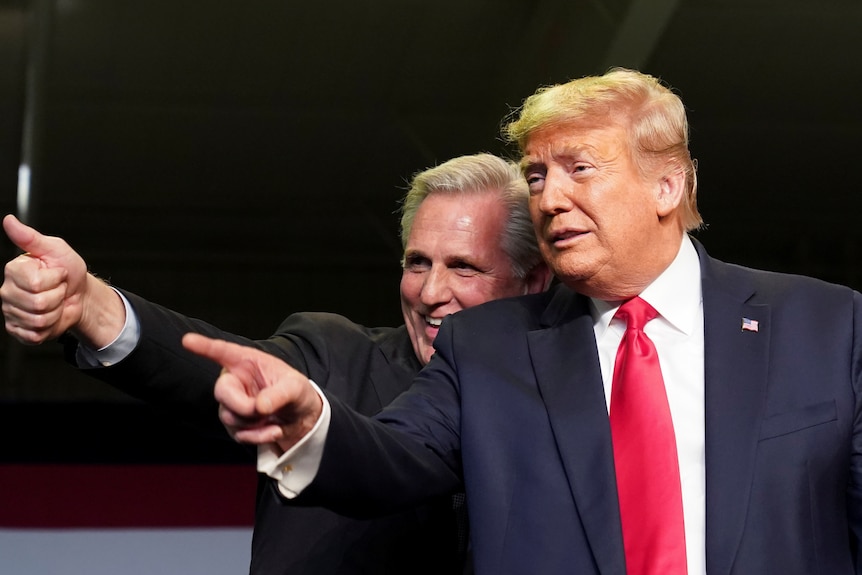 Donald Trump points as Kevin McCarthy laughs and gives a thumbs up behind him