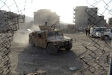 Afghan police arrive at the site of a suicide attack in front of Kabul's military airport