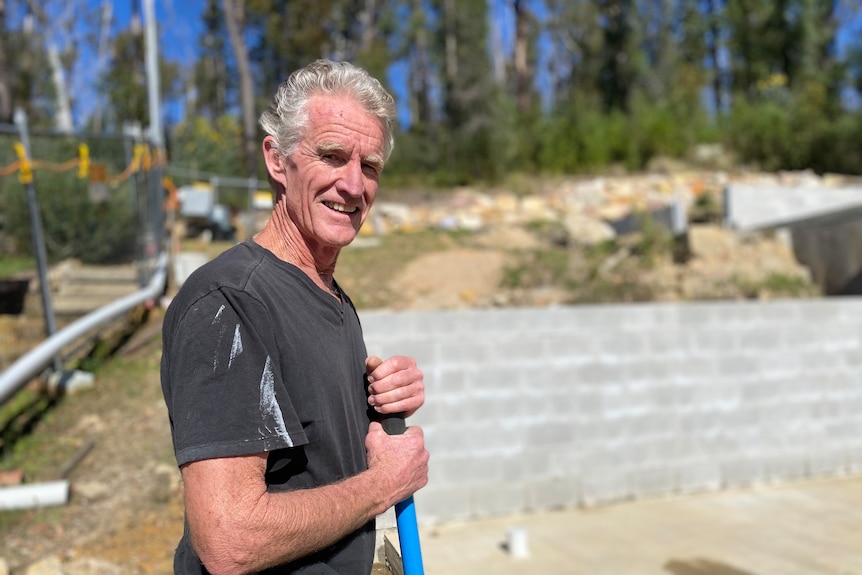 A man holding a shovel on a building site