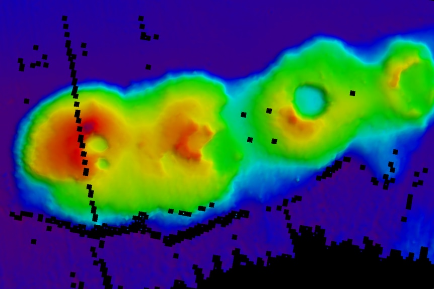 3D image of the ocean floor showing a cluster of three volcanoes.