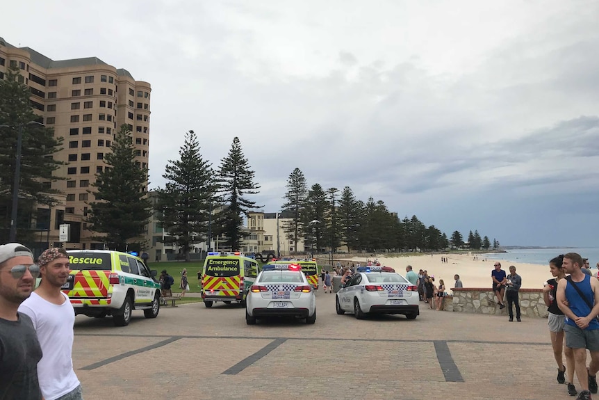 Paramedics and police at Glenelg beach where a 15-year-old boy has drowned