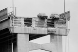 Black and white image of cars hanging over Hobart's Tasman Bridge in 1975 after a section was knocked down by a ship