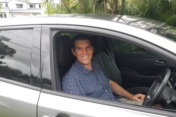 Kobus Terblanche smiling in his electric car in April 2022