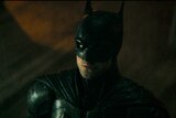 An image from the film The Batman showing Robert Pattison in the costume of the Batman.