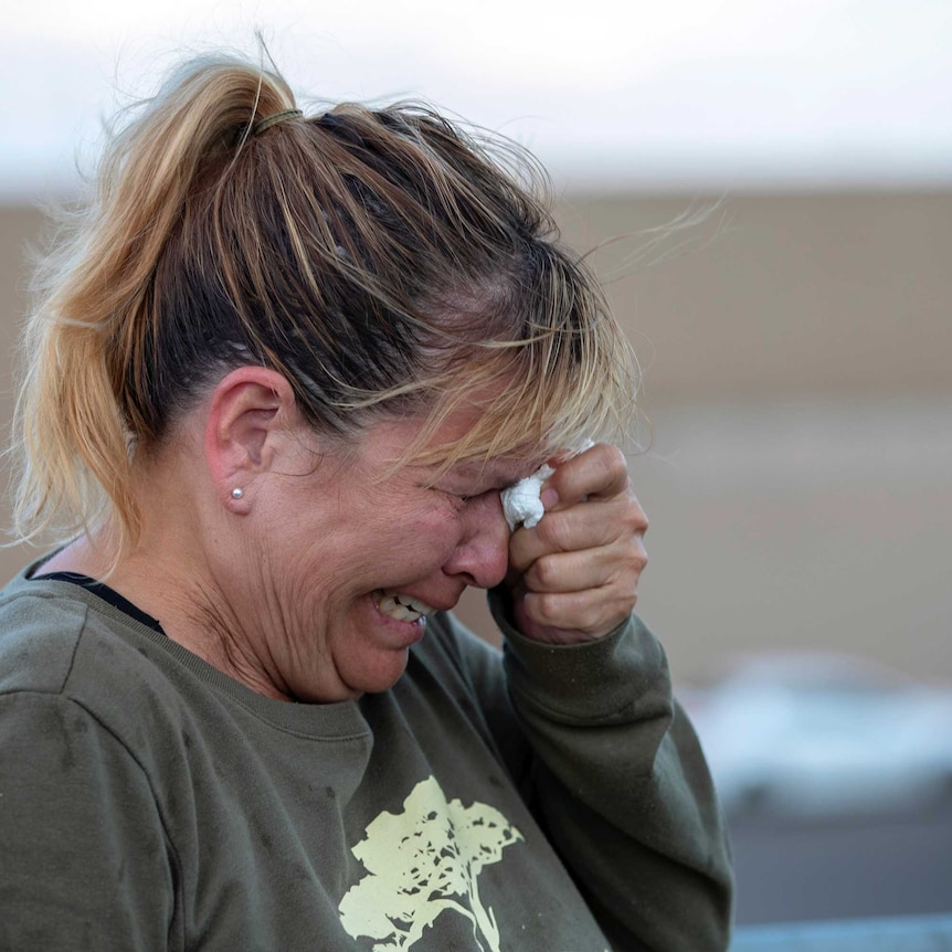 A woman cries while speaking to police outside a Walmart store.