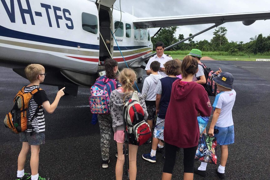 Schoolchildren getting ready to board a fixed-wing aircraft in Tully in north Queensland on March 11, 2018