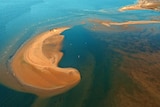 An aerial shot of a wall of silt