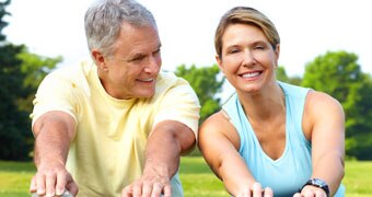 Older people stretching in a park