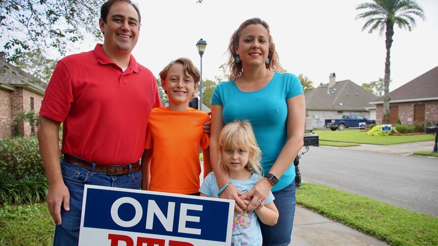 A family smile with a campaign sign
