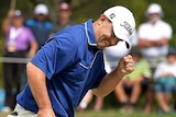 Greg Chalmers of Australia celebrates as he sinks a putt on the 18th hole to take the lead during day four of the 2014 Australian PGA Championship at Royal Pines Resort