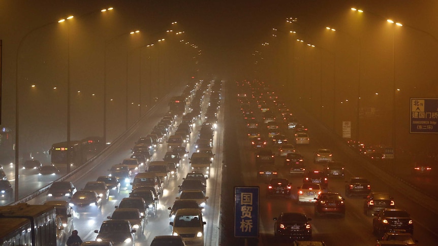 Vehicles drive on the Third Ring Road as the smog blankets the city.
