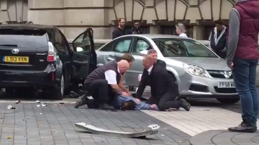 Still from a video showing a man being pinned down on the ground after the incident near London's Natural History Museum.