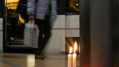 Candles burn on the platform of Madrid's Atocha rail station