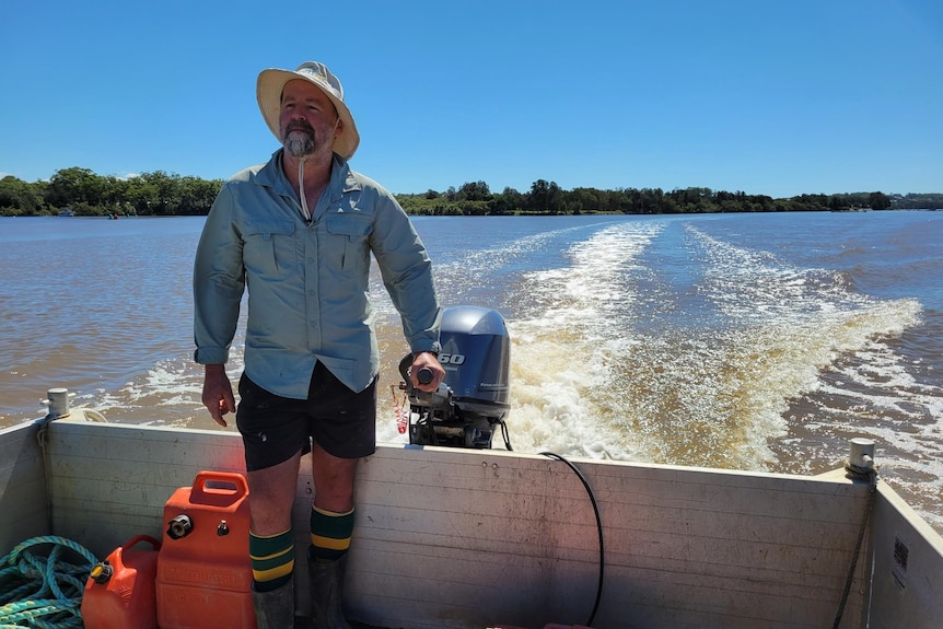 Oyster farmer James Ford steers his boat on the Nambucca River.