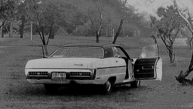 A black and white photo of a car with its two front doors open