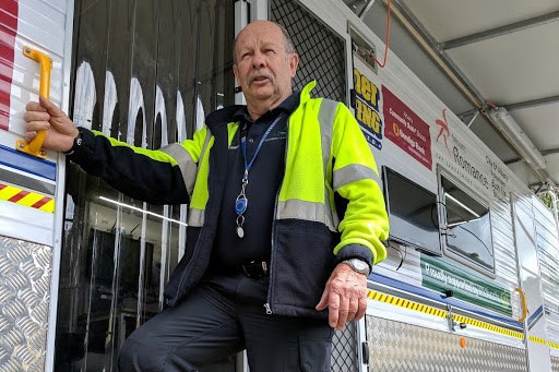 Garry Turner leaning against the city's new fire management vehicle.