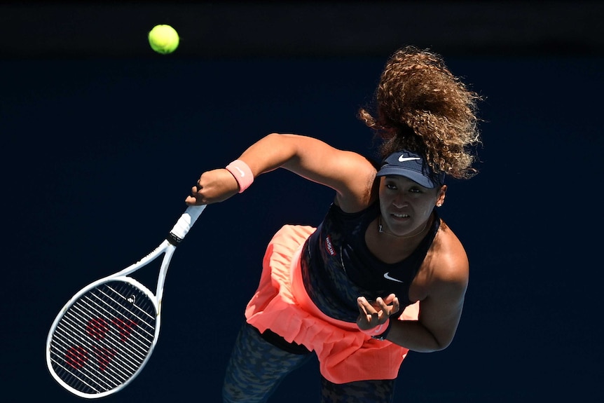 Naomi Osaka serves to Serena Williams in their Australian Open semi-final at Melbourne Park.