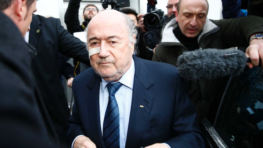 FIFA President Sepp Blatter is surrounded by media as he arrives for a news conference in Zurich