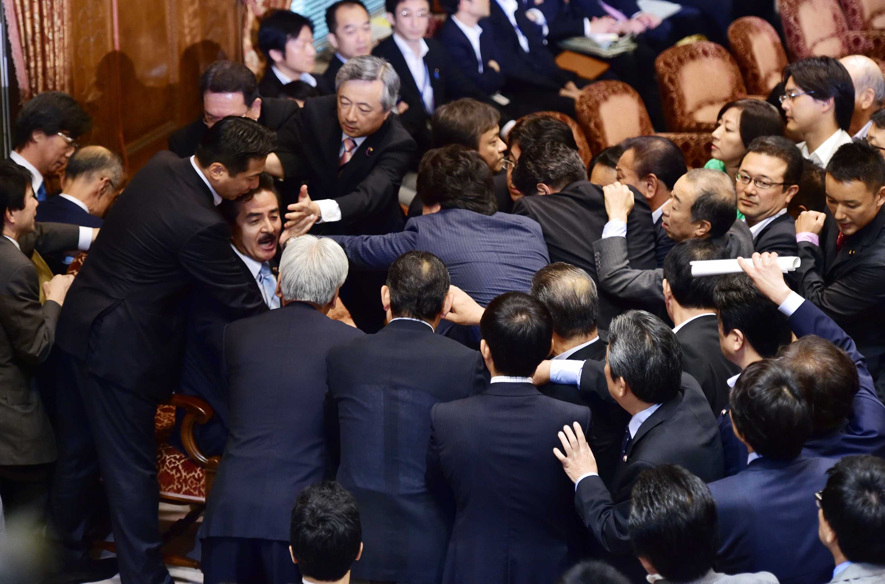 Opposition MPs rush Japanese panel chief during security policy debate