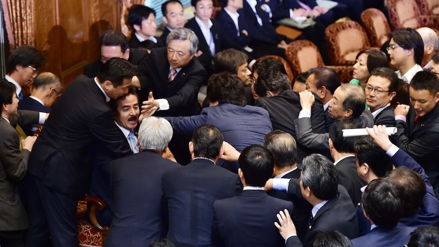 Opposition MPs rush Japanese panel chief during security policy debate