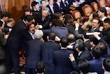 Opposition MPs rush Japanese panel chief during security policy debate