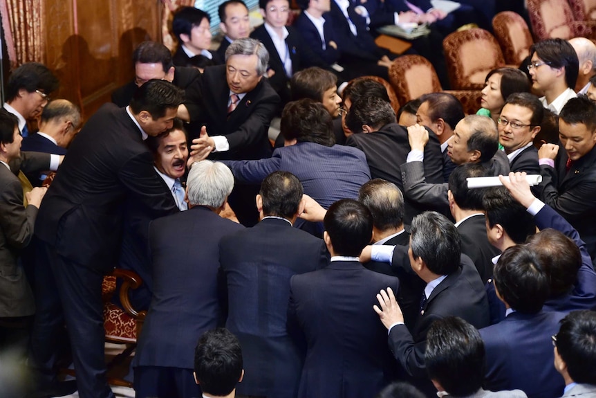 Opposition MPs rush Japanese panel chief during security policy debate