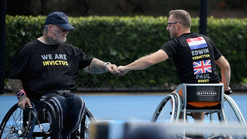 Wheelchair doubles partners Paul Guest and Edwin Vermetten share a fist bump on court.