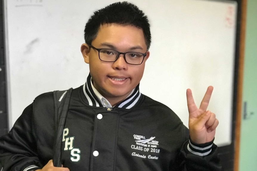 Condell Park High School student, Anton Castro, gives the V for victory sign
