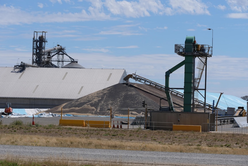 Large grain sheds, mounds of grain and mechanical towers in western Victoria.