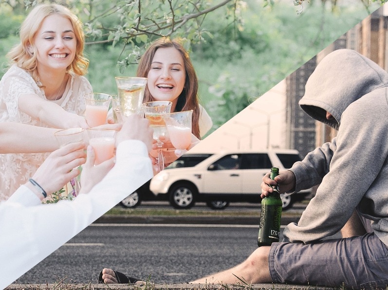 A group of girls cheers their glasses, while a man sits by a highway with a bottle of alcohol