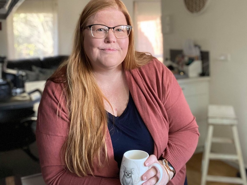 a woman with a cup of tea at home