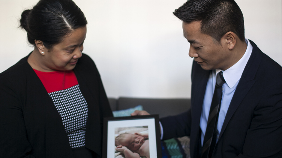 Debbie and Minh hold a picture of their stillborn daughter Zoe, Sydney August 2016