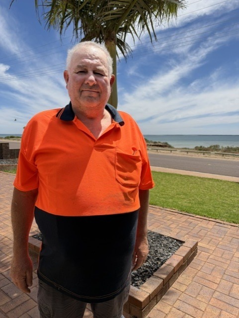 Mario Nicholls, in high vis, looks at the camera.