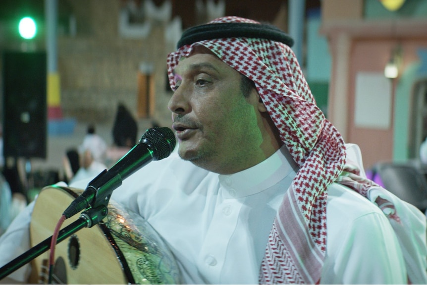 Film still of Khalid Abdulraheem as Abdulaziz performing at a wedding in The Perfect Candidate