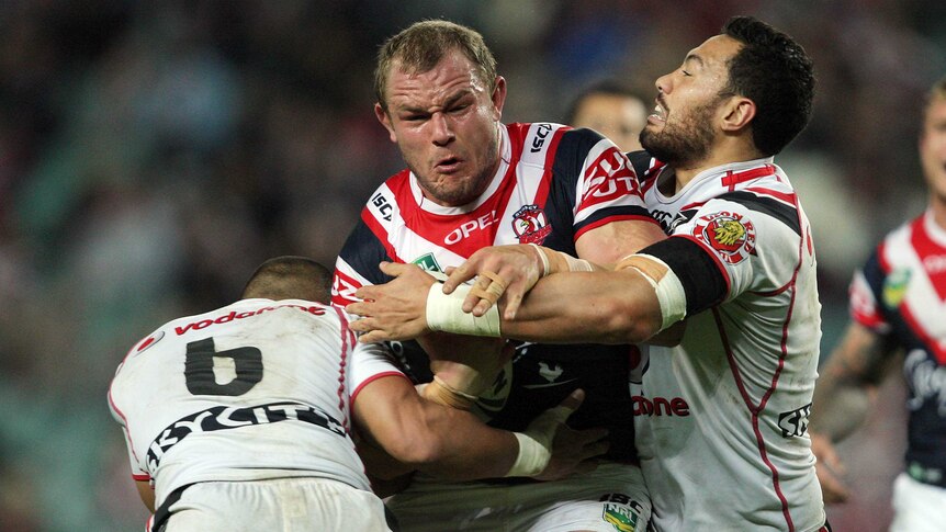 Martin Kennedy fights for yards for the Roosters