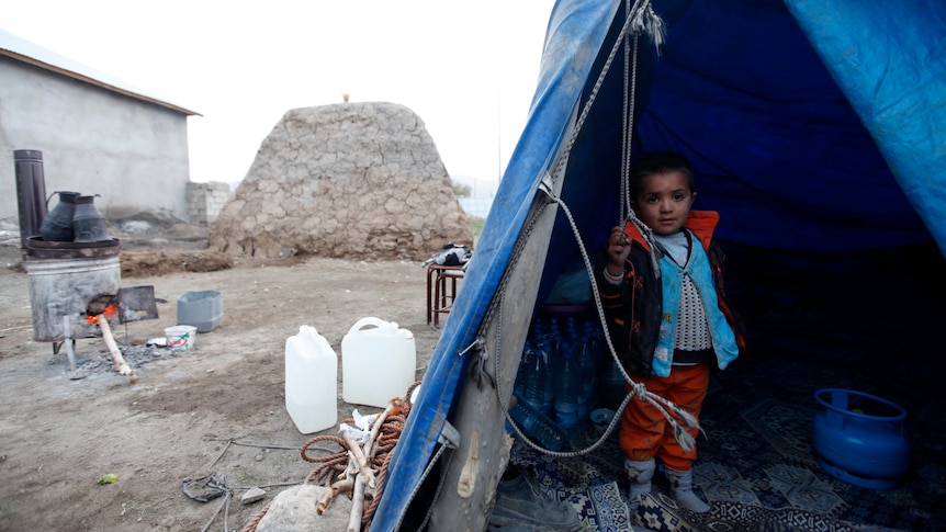 Turkish toddler in makeshift tent