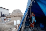 Turkish toddler in makeshift tent