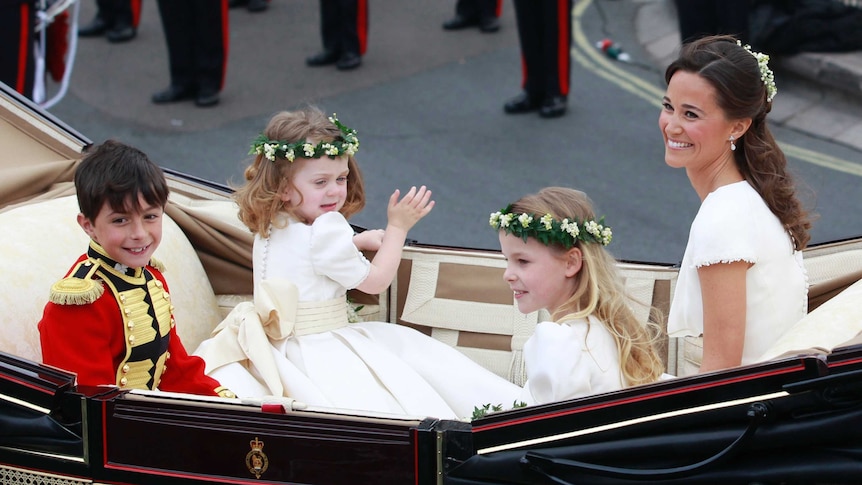 Pippa shares a carriage with the children in the bridal party.