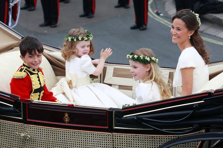 Pippa shares a carriage with the children in the bridal party.