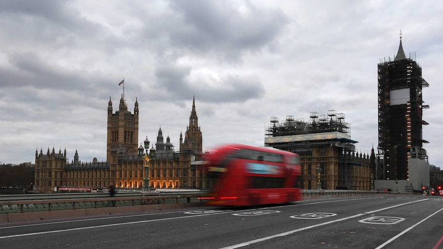 A double decker bus drives along an empty Westminster Bridge.