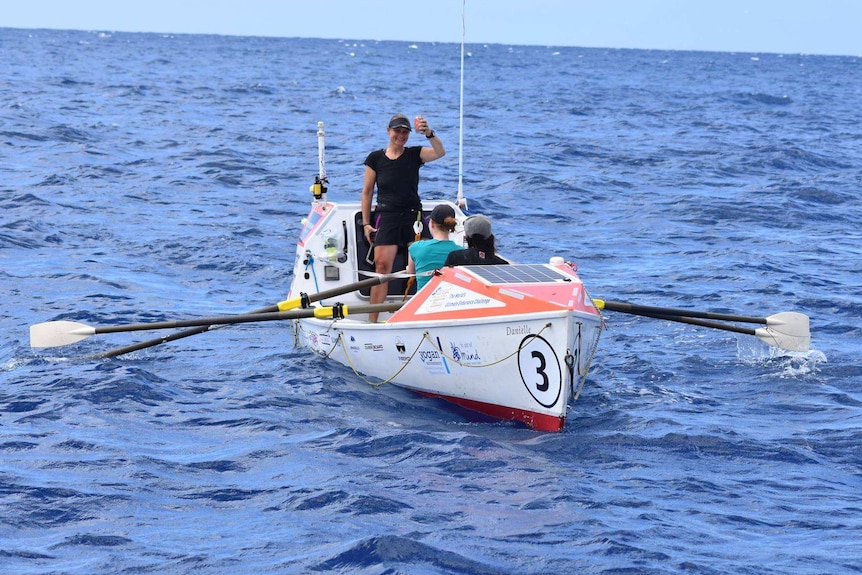 Three women in 7.6m row boat.