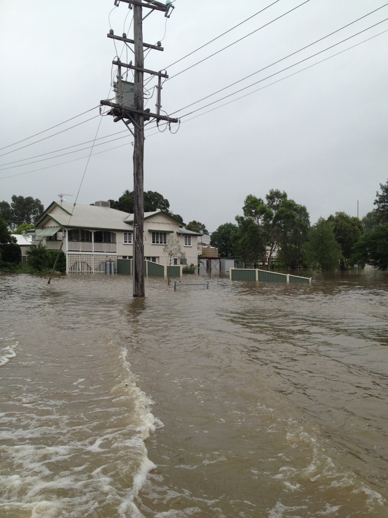 Floodwaters course down a street in Roma