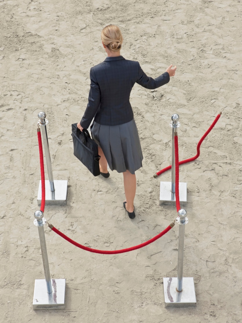 A woman walking through a roped off area