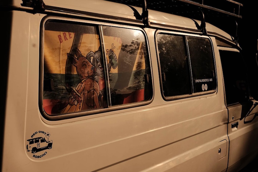 An old white Troopy 4WD, with a towel covering its window.