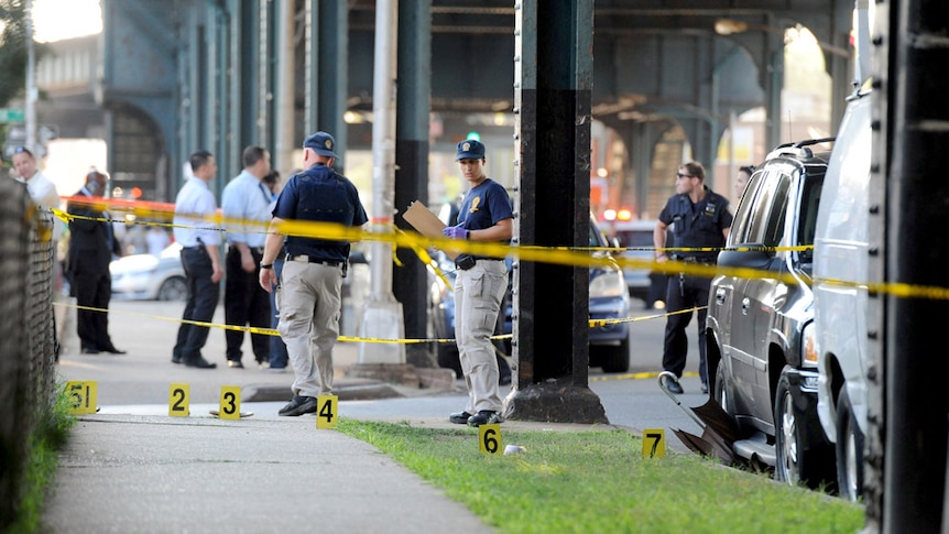Yellow tape surrounds New York City Police, who are establishing a crime scene in the Queens Borough.